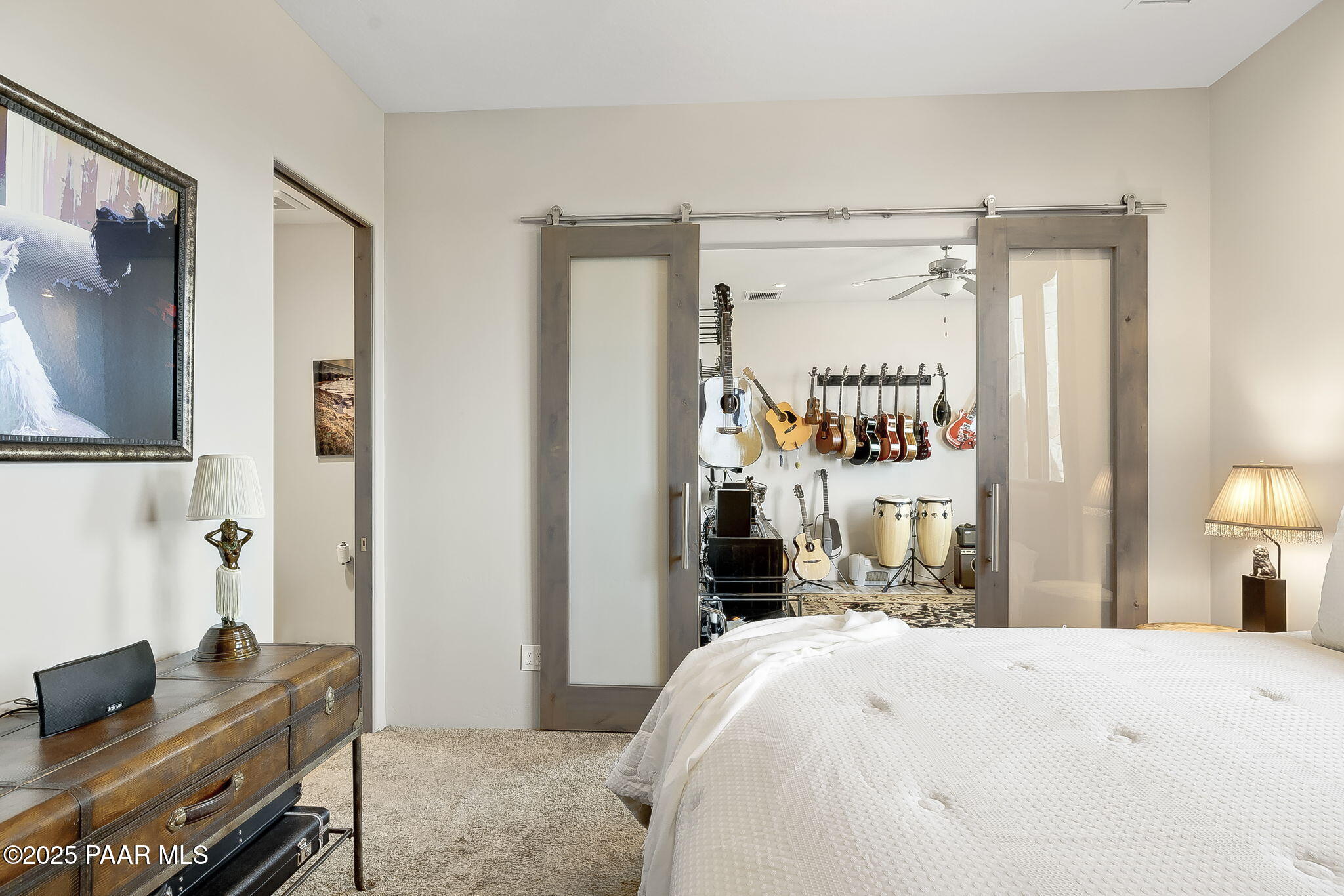 5245 West Three Forks Road Prescott, AZ 86305 - Photo 41 of 68 a bedroom with a bed and a chandelier