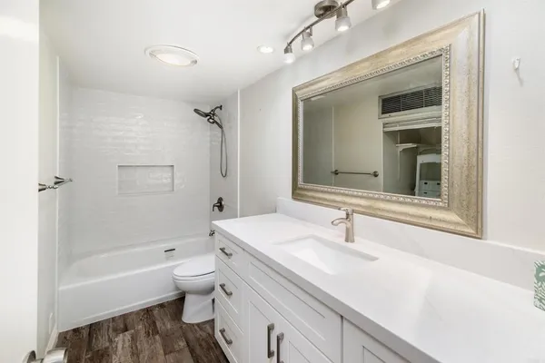 a bathroom with a sink a toilet and a bathtub