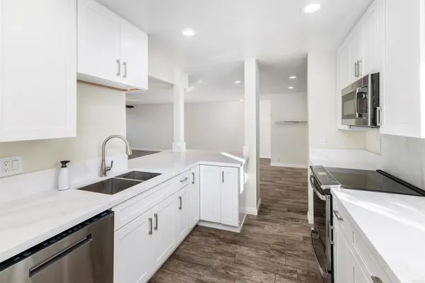 a kitchen with a sink cabinets and a refrigerator