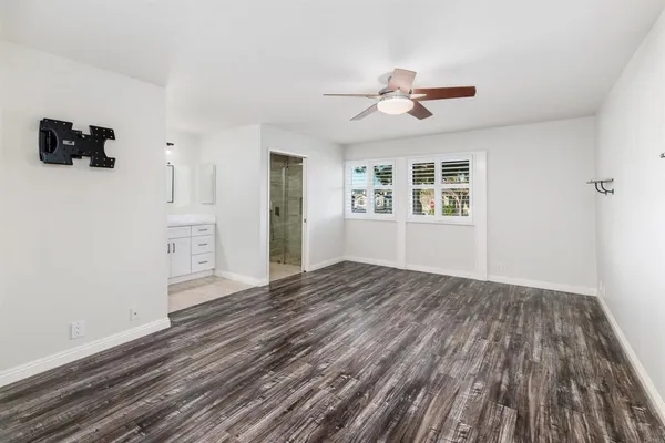 wooden floor in an empty room with a window