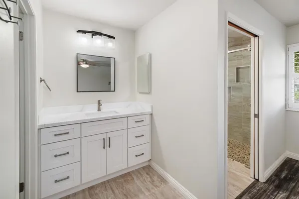 a bathroom with mirror sink and vanity
