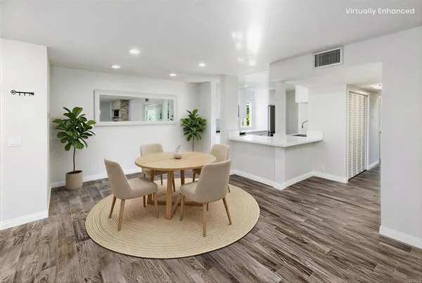 a dining room with furniture and wooden floor