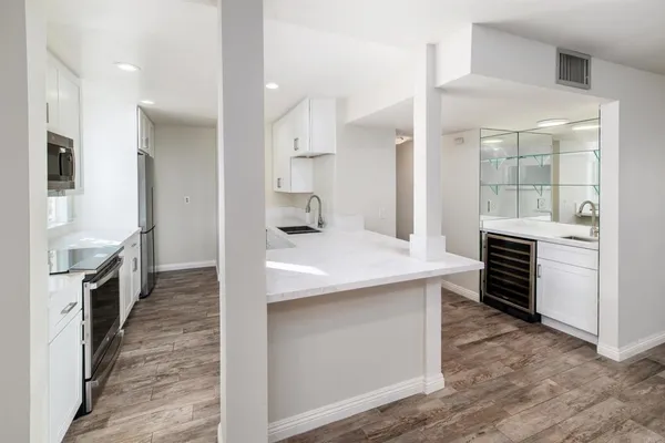 a kitchen with refrigerator cabinets and a stove