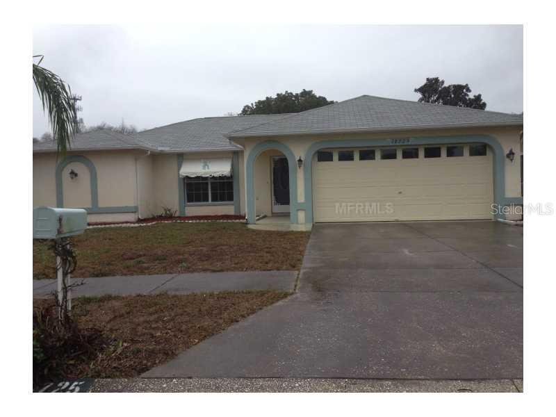 18725 Parade Road Hudson, FL 34667 - Photo 1 of 1 a view of a house with a small yard and large window