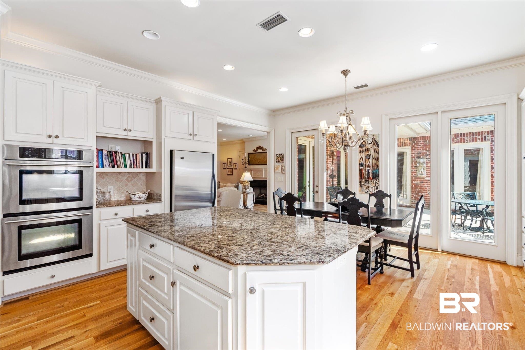 3963 Wimbledon Park Mobile, AL 36608 - Photo 11 of 51 Kitchen featuring light hardwood / wood-style floors, stainless steel appliances, a healthy amount of sunlight, and white cabinets