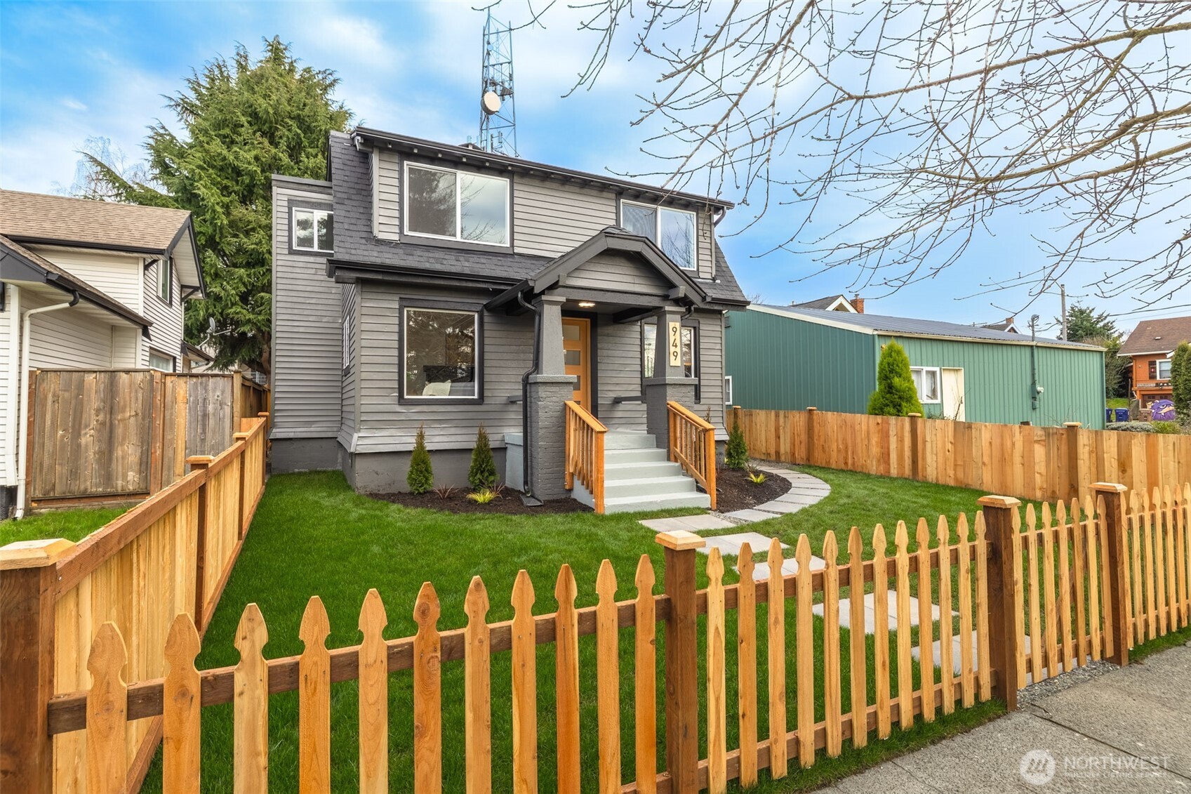 949 South Ridgewood Avenue Tacoma, WA 98405 - Photo 3 of 39 a front view of a house with wooden fence