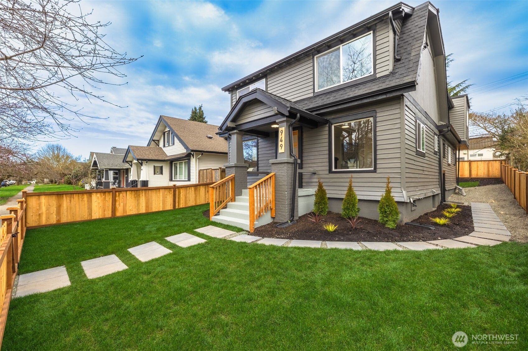 949 South Ridgewood Avenue Tacoma, WA 98405 - Photo 6 of 39 a front view of a house with a yard table and chairs