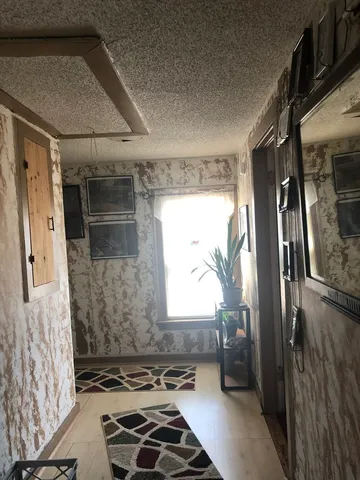 a bathroom with a window and a shower