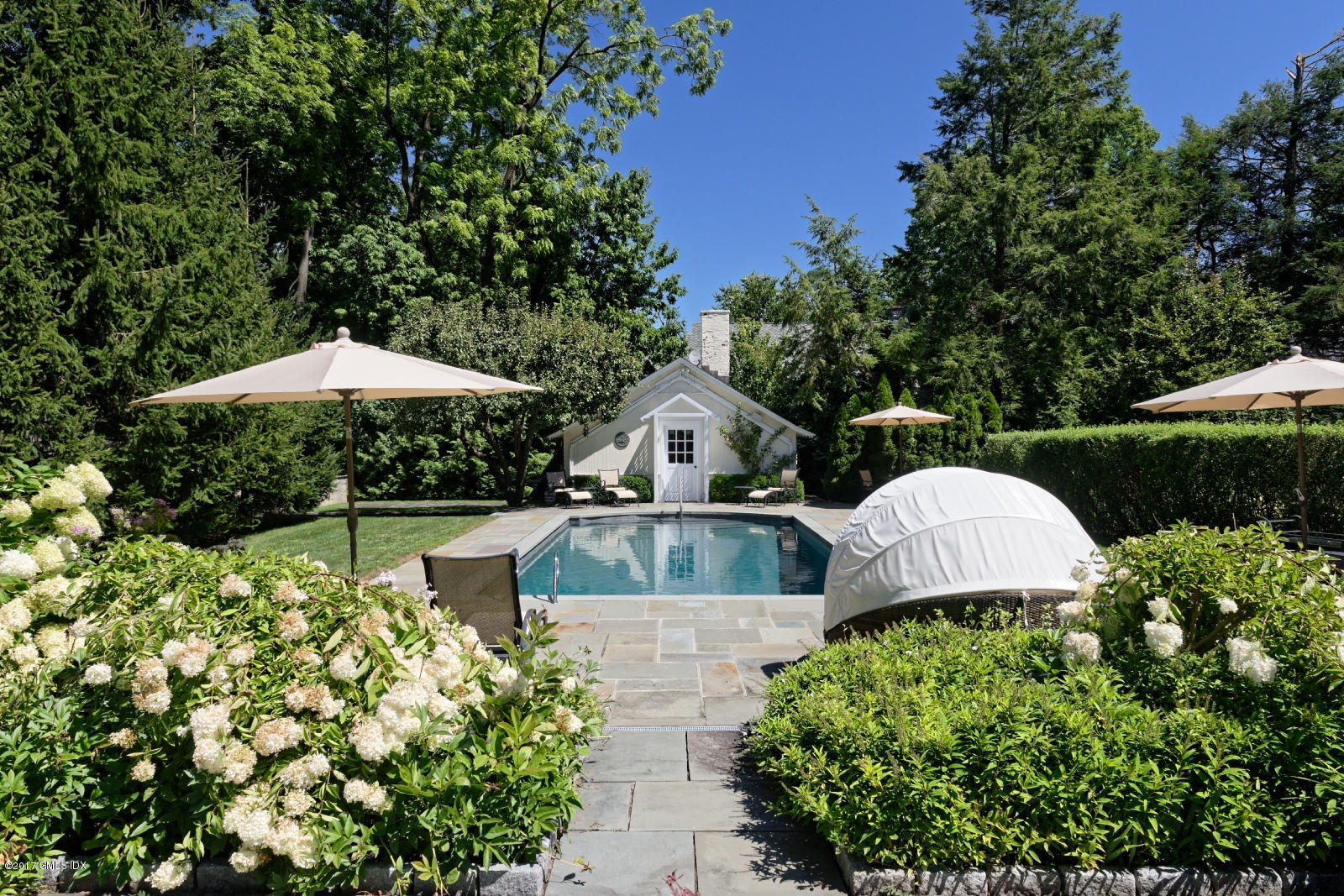171 North Maple Avenue Greenwich, CT 06830 - Photo 14 of 16 a front view of a house with swimming pool and porch with furniture