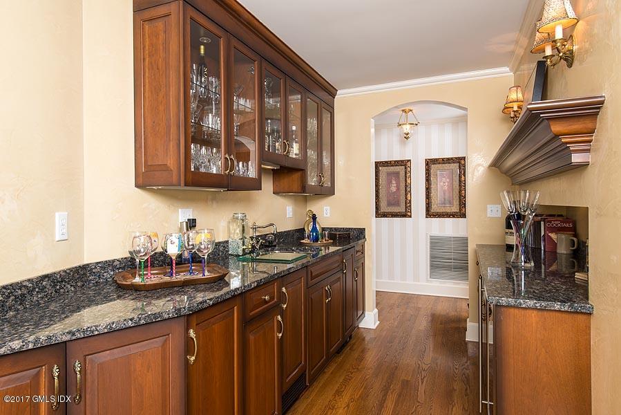 171 North Maple Avenue Greenwich, CT 06830 - Photo 6 of 16 a kitchen with stainless steel appliances granite countertop a sink stove and cabinets