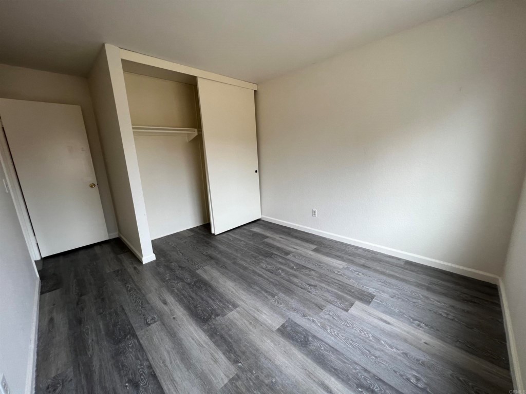 7780 Embry Point San Diego, CA 92126 - Photo 11 of 14 an empty room with wooden floor and entrance