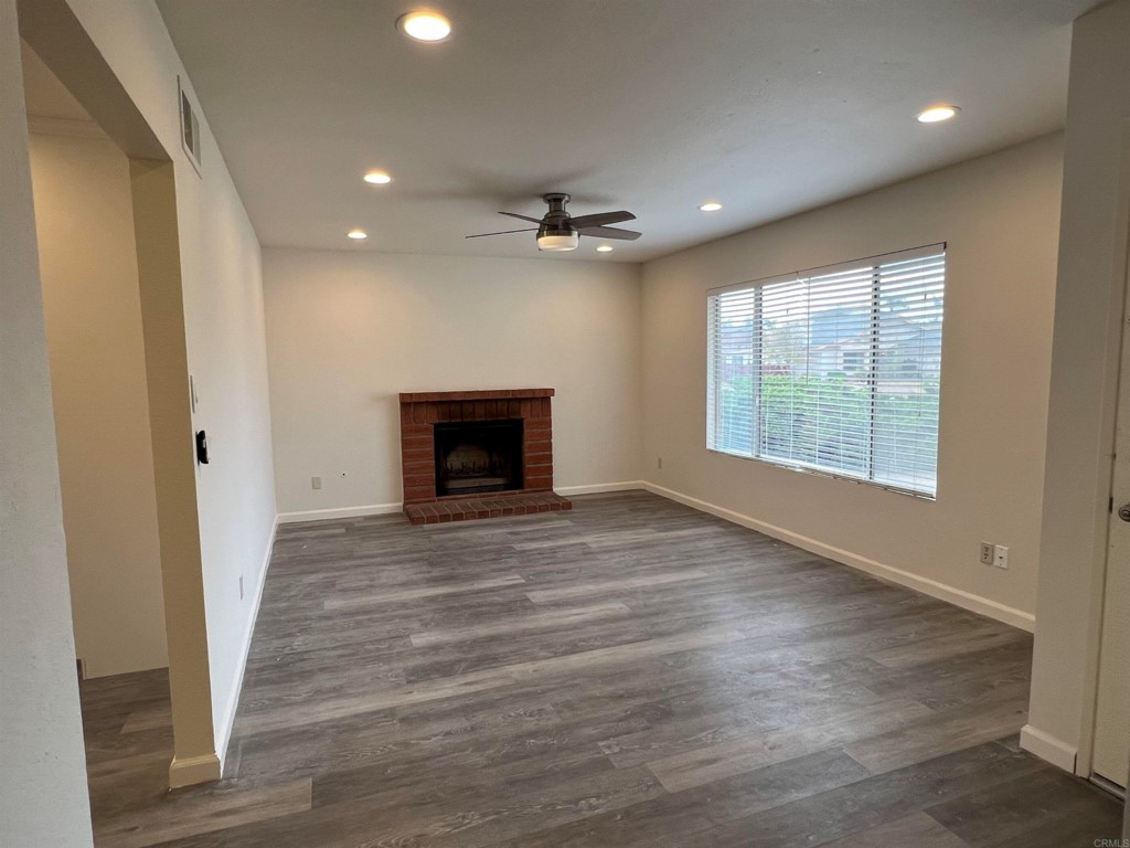 7780 Embry Point San Diego, CA 92126 - Photo 6 of 14 an empty room with windows and a fireplace