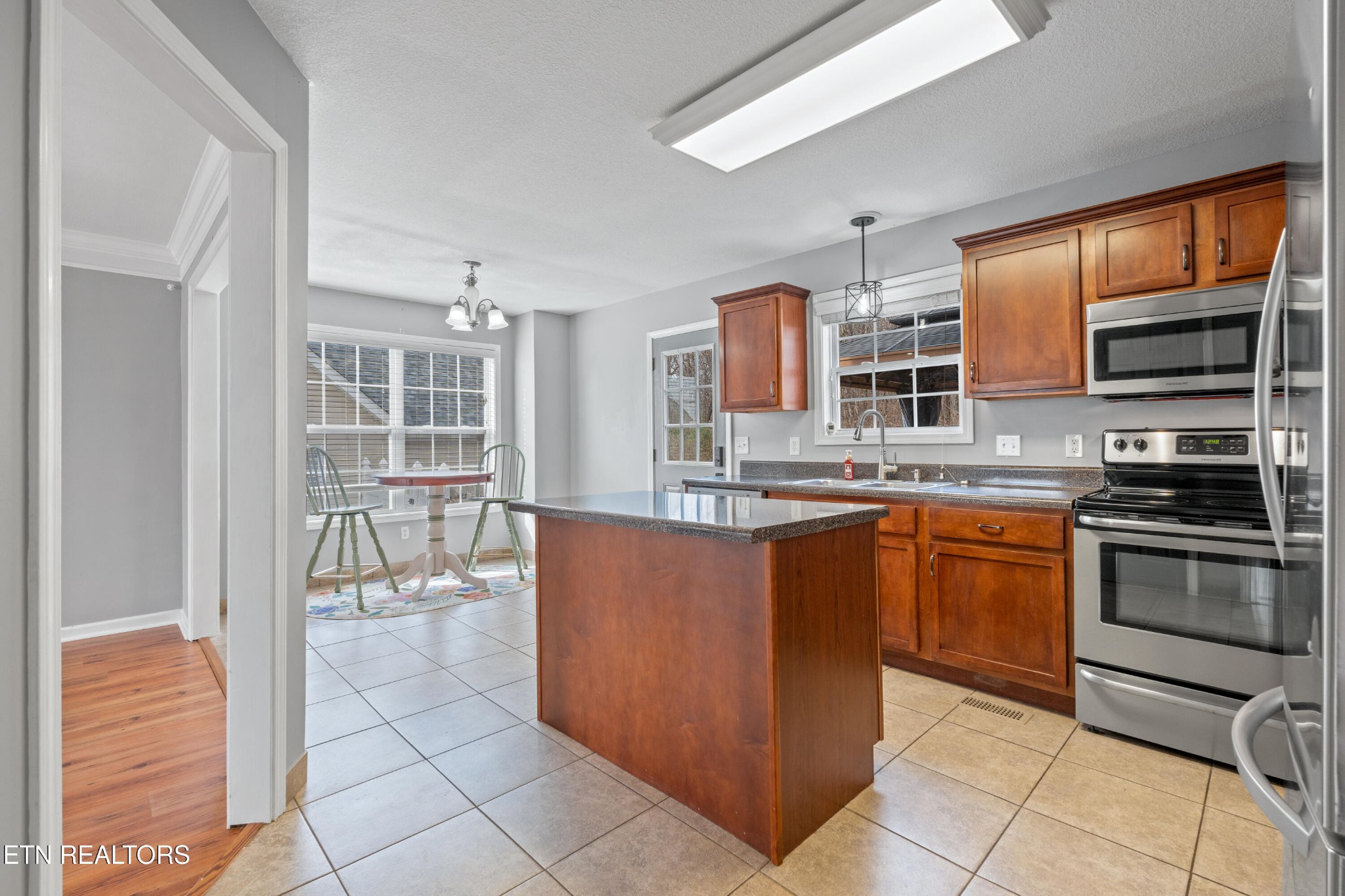 2805 Porch Swing Road Knoxville, TN 37938 - Photo 11 of 48 a kitchen with stainless steel appliances granite countertop a stove top oven a sink a counter space and cabinets