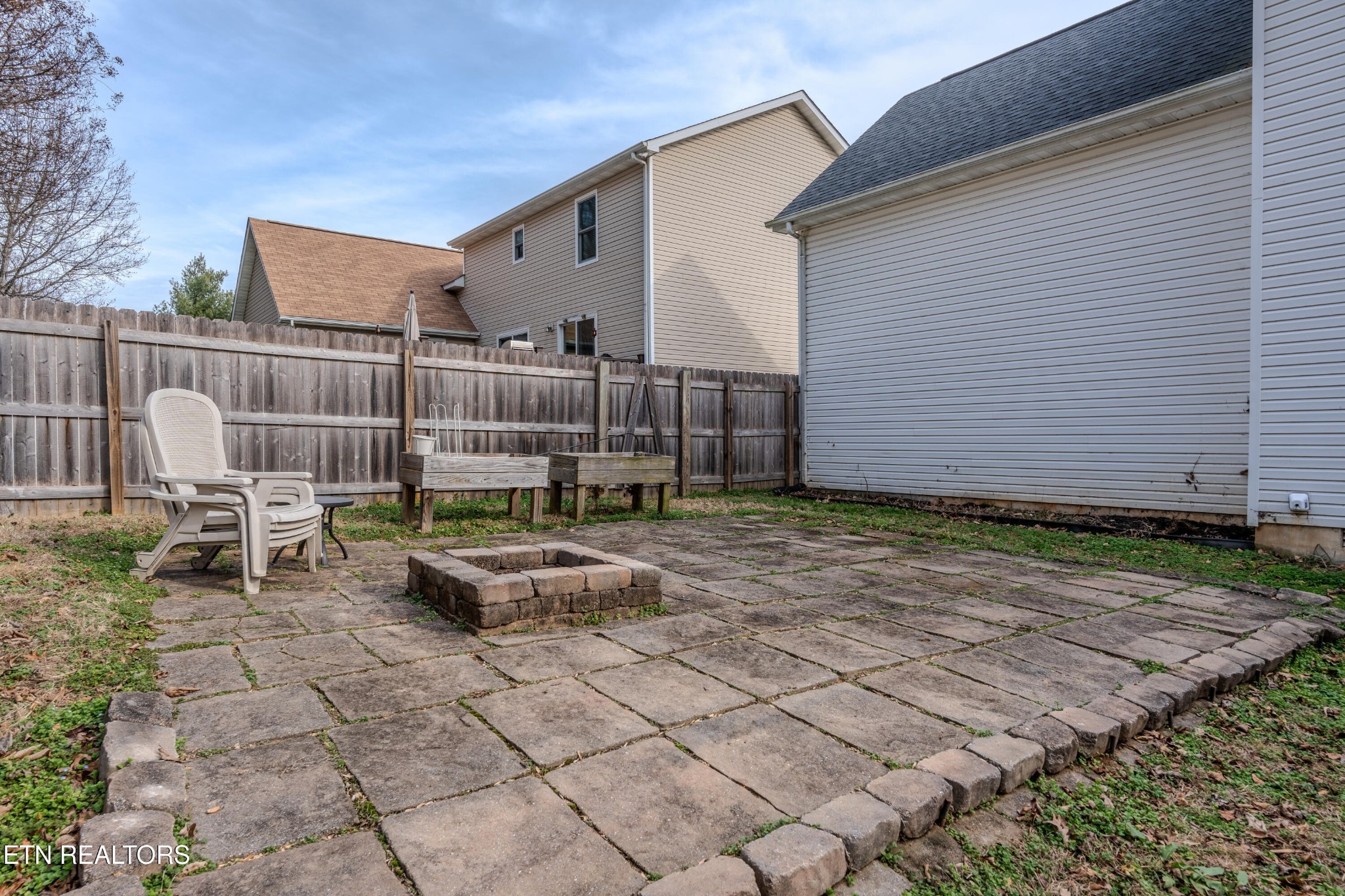 2805 Porch Swing Road Knoxville, TN 37938 - Photo 45 of 48 a backyard of a house with chairs and wooden fence