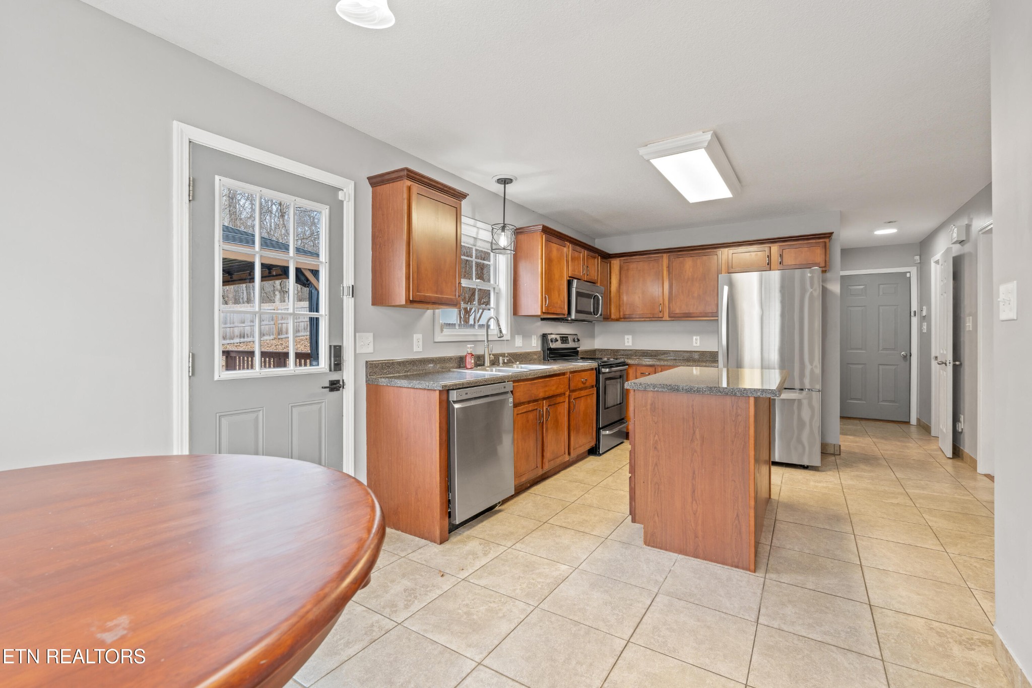 2805 Porch Swing Road Knoxville, TN 37938 - Photo 7 of 48 a kitchen with stainless steel appliances granite countertop a stove a sink a refrigerator and a refrigerator