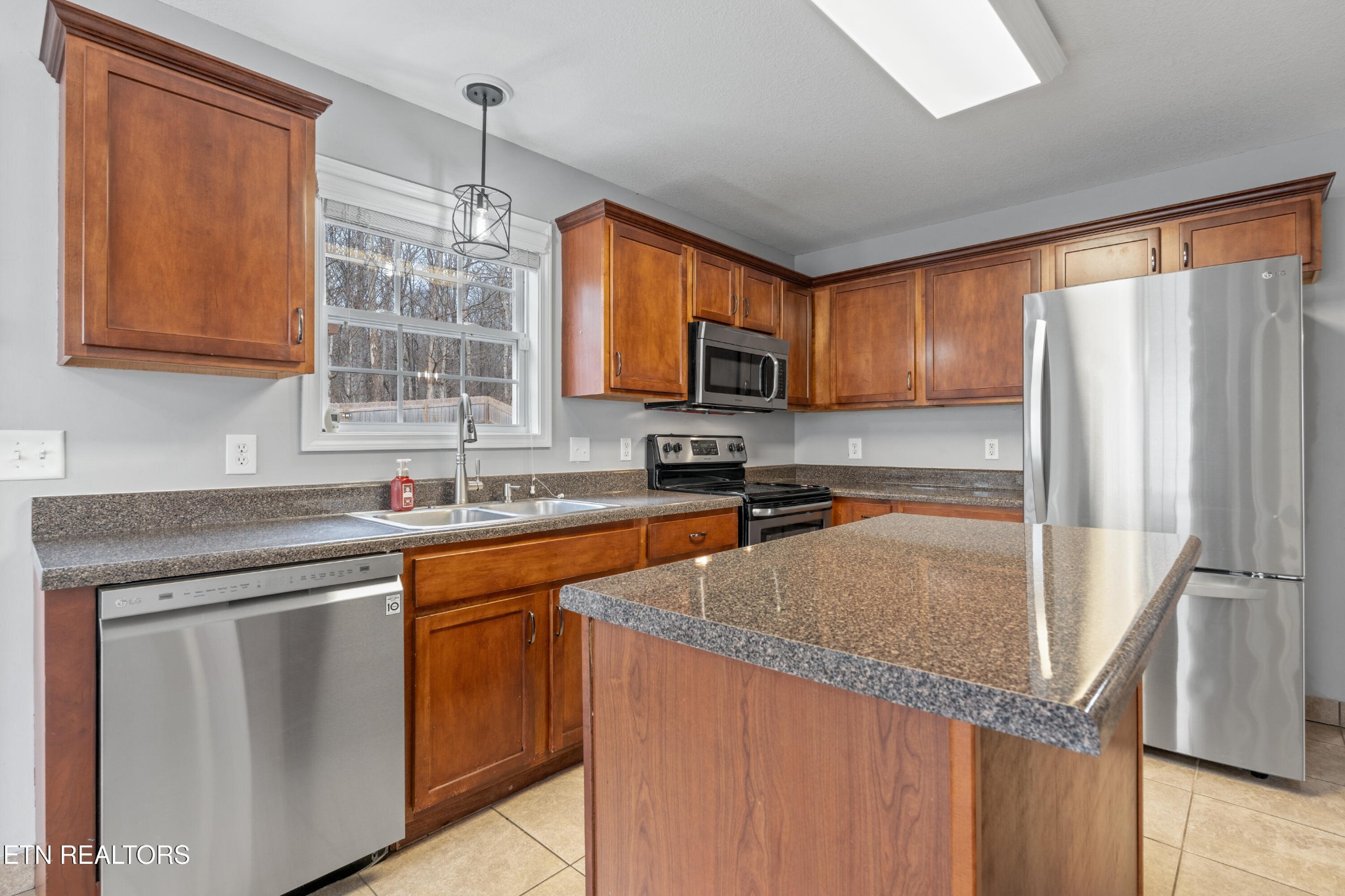 2805 Porch Swing Road Knoxville, TN 37938 - Photo 8 of 48 a kitchen with stainless steel appliances granite countertop a sink stove and refrigerator