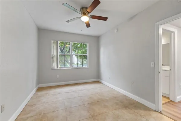 a view of room with a ceiling fan and window