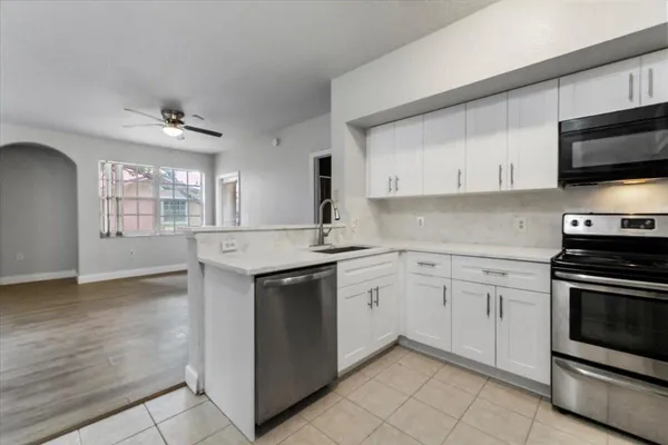 a kitchen with stainless steel appliances granite countertop a sink and a stove