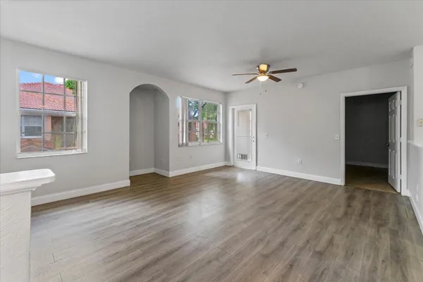 wooden floor in an empty room with a window
