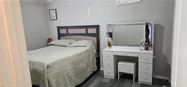 a bedroom with a bed and a mirror