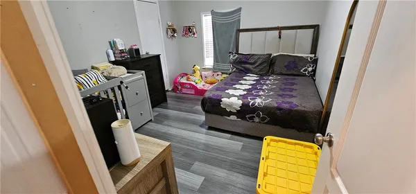 a bed room with furniture and a flat tv screen