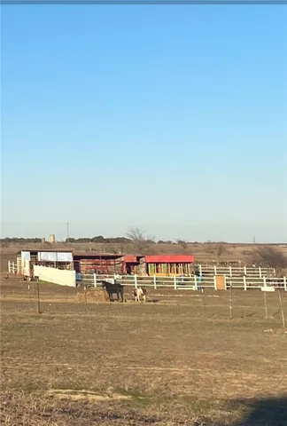 a room with a book shelf and a floor to ceiling window