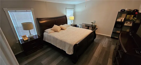 a bed sitting in a bedroom next to a window