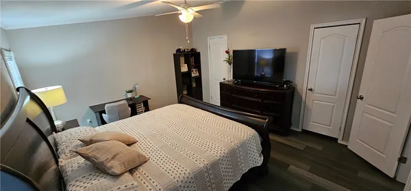 a bedroom with a bed and a flat screen tv