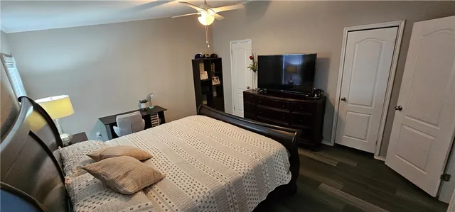a bedroom with a bed and a flat screen tv