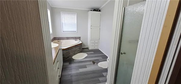 a bathroom with a granite countertop toilet and a sink