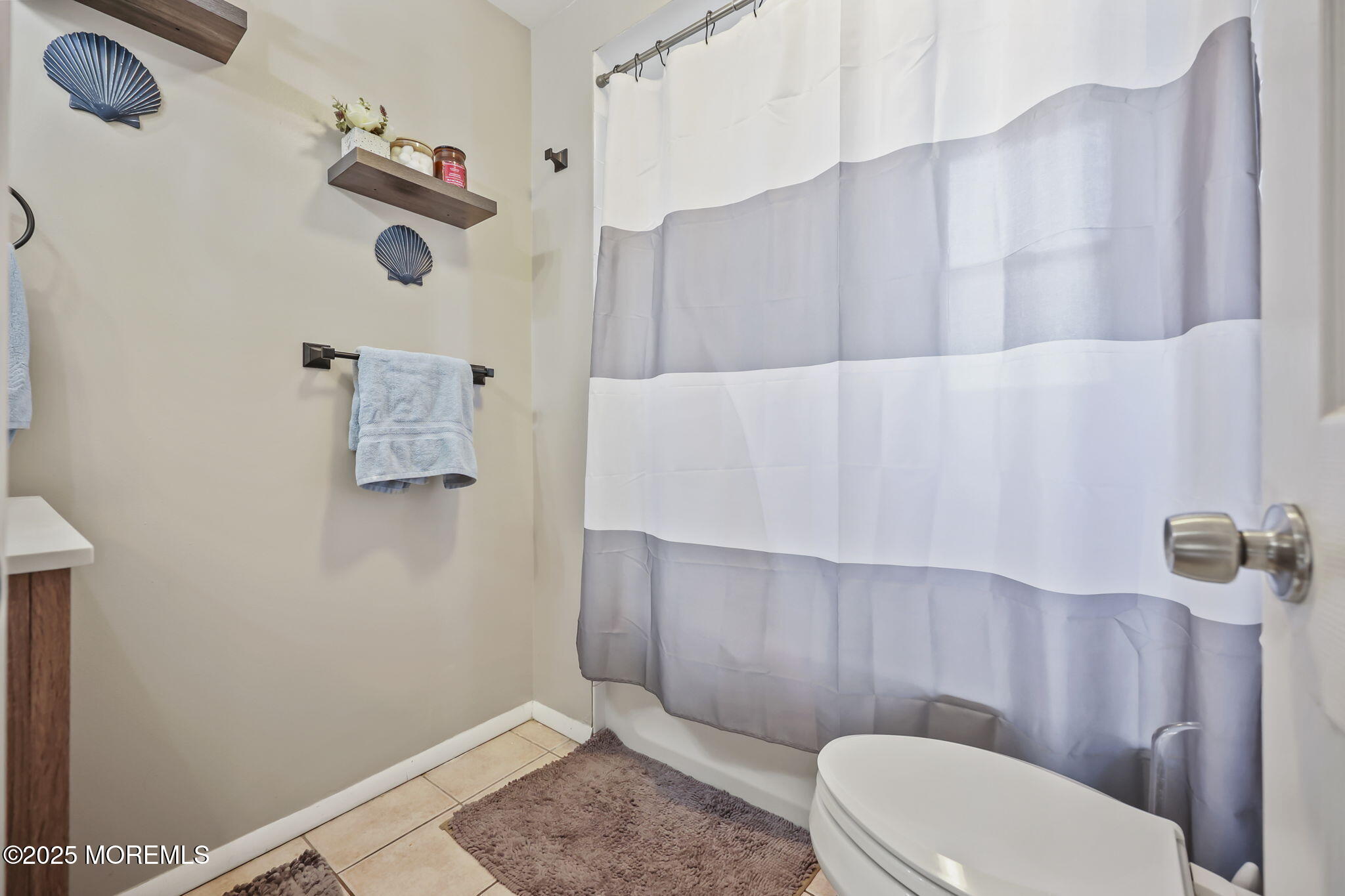 13 Holly Road Brick, NJ 08723 - Photo 11 of 34 a white toilet sitting next to a wooden cabinet