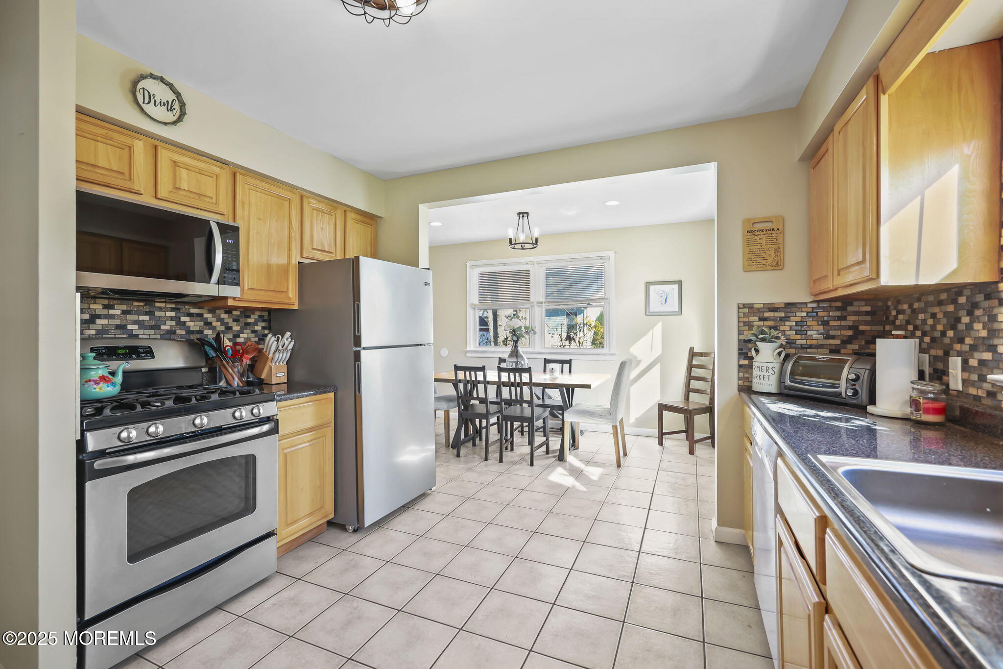 13 Holly Road Brick, NJ 08723 - Photo 15 of 34 a kitchen with stainless steel appliances granite countertop a stove a sink and a refrigerator