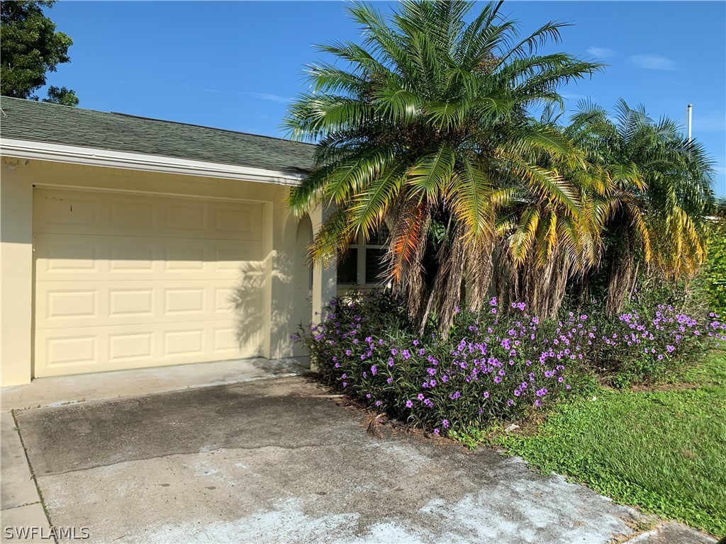 2219 Lily Road Fort Myers, FL 33905 - Photo 2 of 23 a couple of potted plants in front of a house