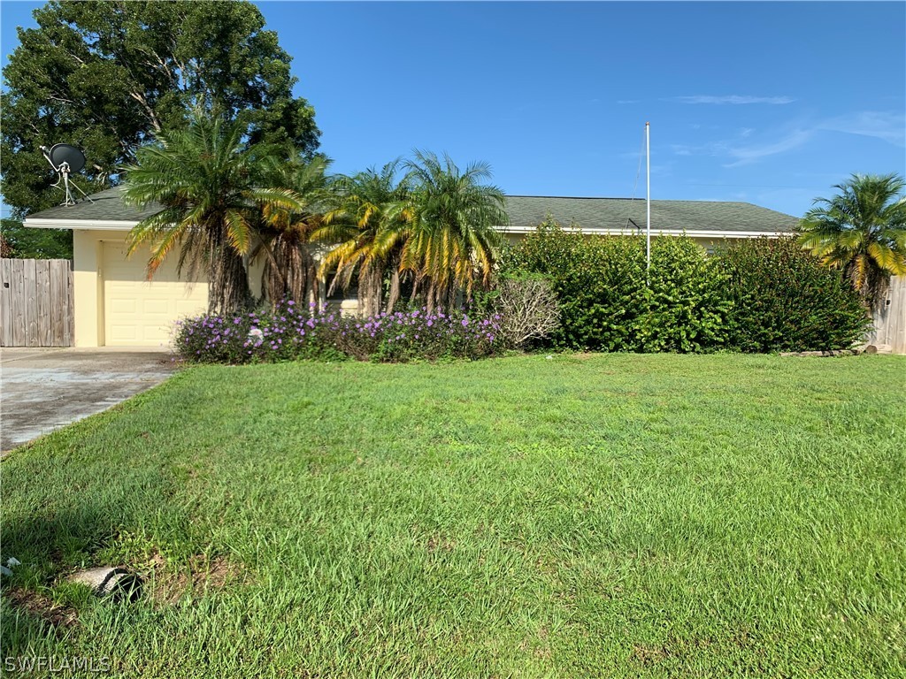2219 Lily Road Fort Myers, FL 33905 - Photo 4 of 23 a view of a yard and a palm tree