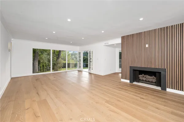 a view of an empty room with a fireplace