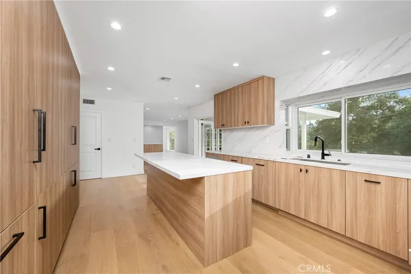 a kitchen with stainless steel appliances a refrigerator and a sink