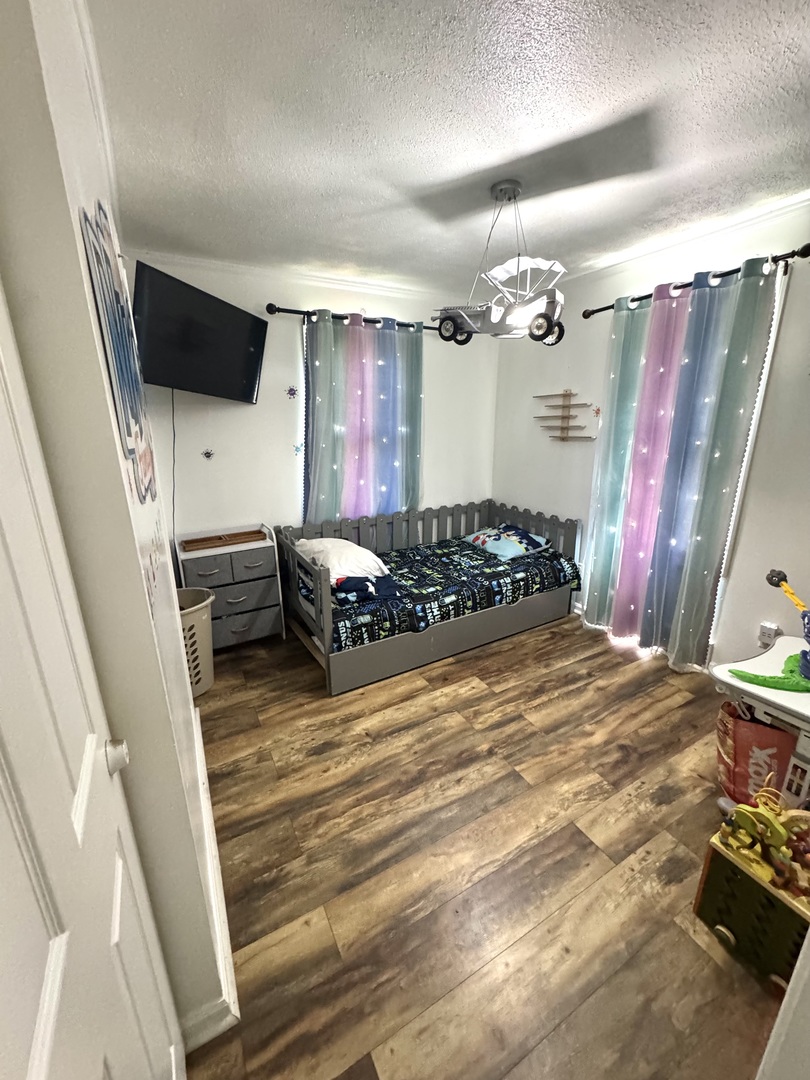 931 South Rawson Bridge Road Cary, IL 60013 - Photo 33 of 36 a bedroom with a bed window and a flat screen tv