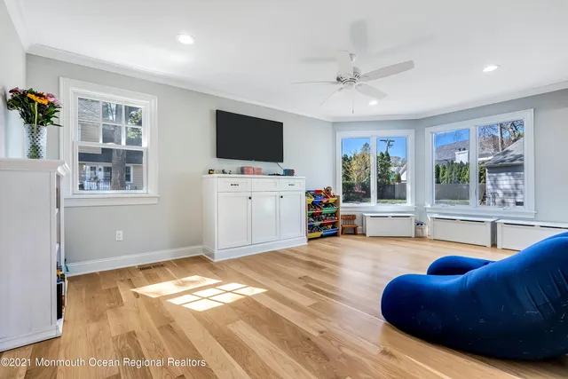 a living room with furniture window and flat screen tv