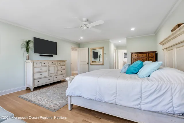 a bedroom with a bed and a television