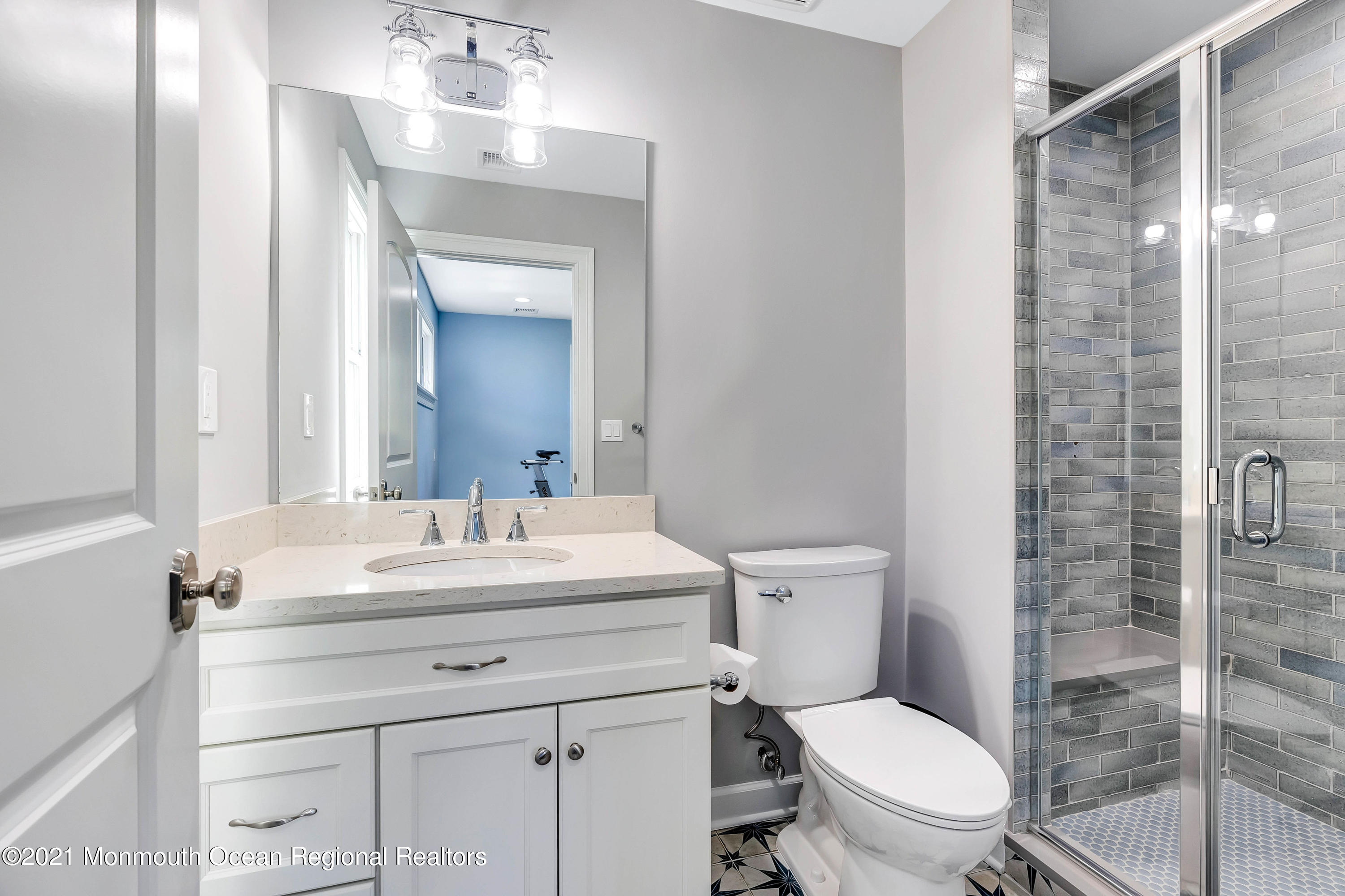 211 Monroe Avenue Spring Lake, NJ 07762 - Photo 25 of 46 a bathroom with a sink a toilet a mirror and shower