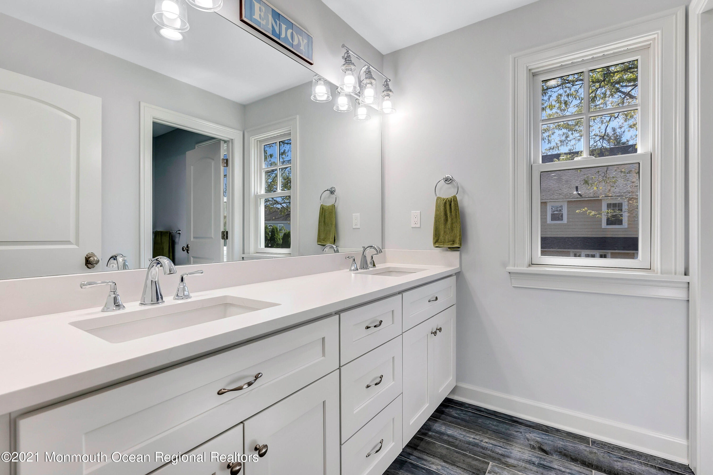 211 Monroe Avenue Spring Lake, NJ 07762 - Photo 26 of 46 a bathroom with a double vanity sink and a mirror