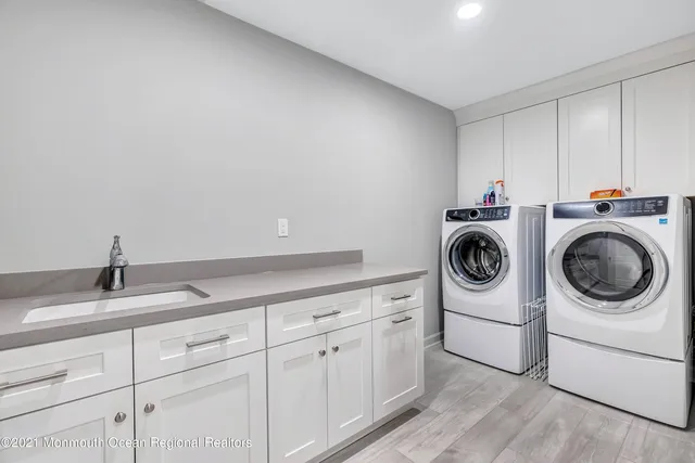 a utility room with sink dryer and washer