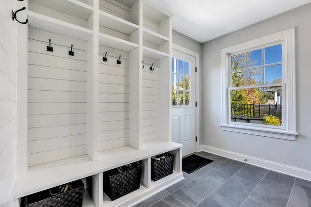 a hallway with front door and wooden floor