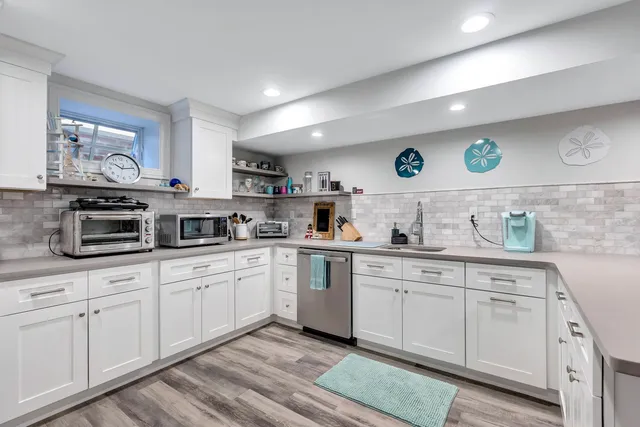 a kitchen with cabinets stainless steel appliances and a sink
