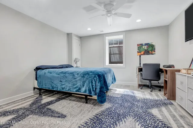 a bedroom with a bed a desk and chair