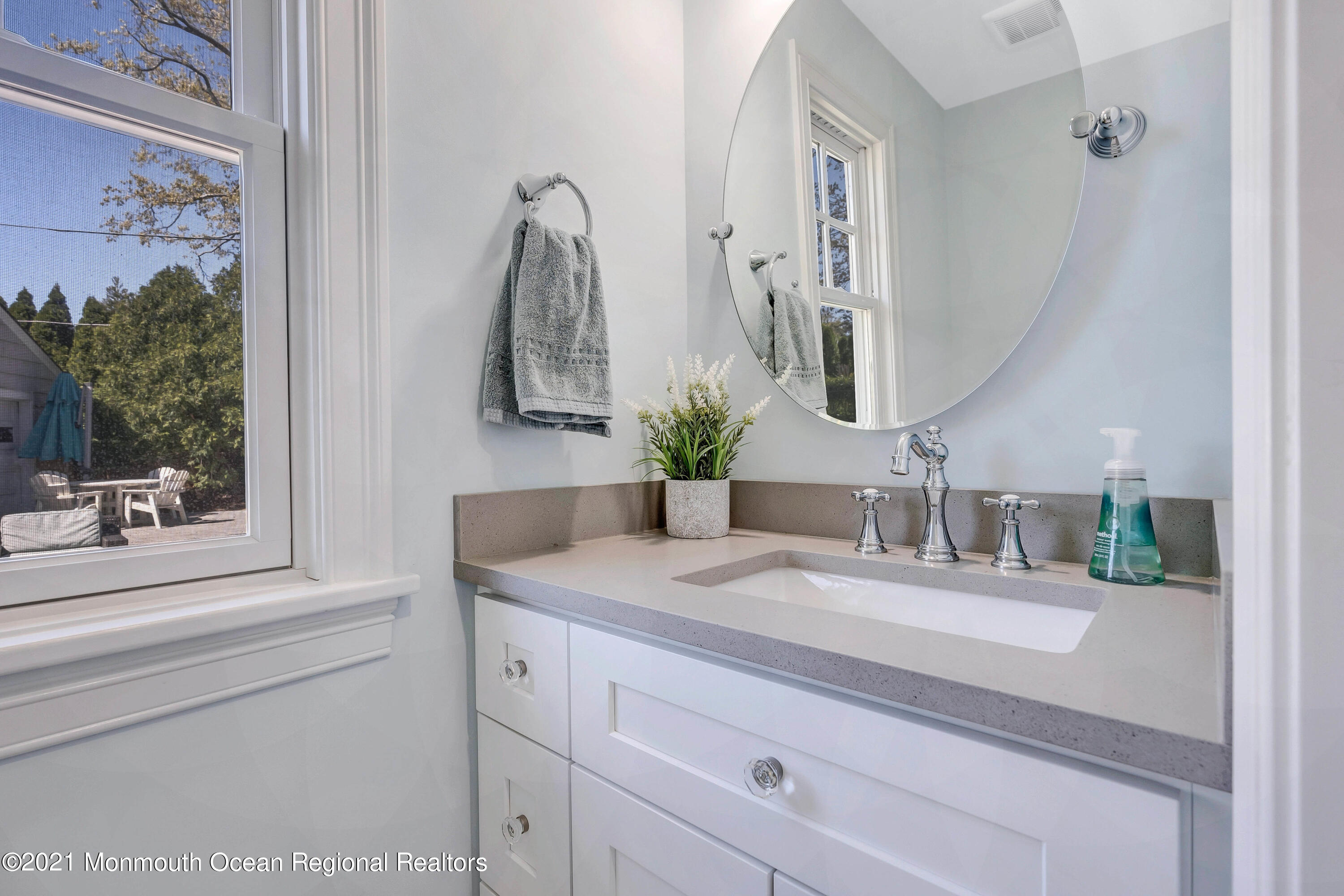211 Monroe Avenue Spring Lake, NJ 07762 - Photo 40 of 46 a bathroom with a sink and a mirror