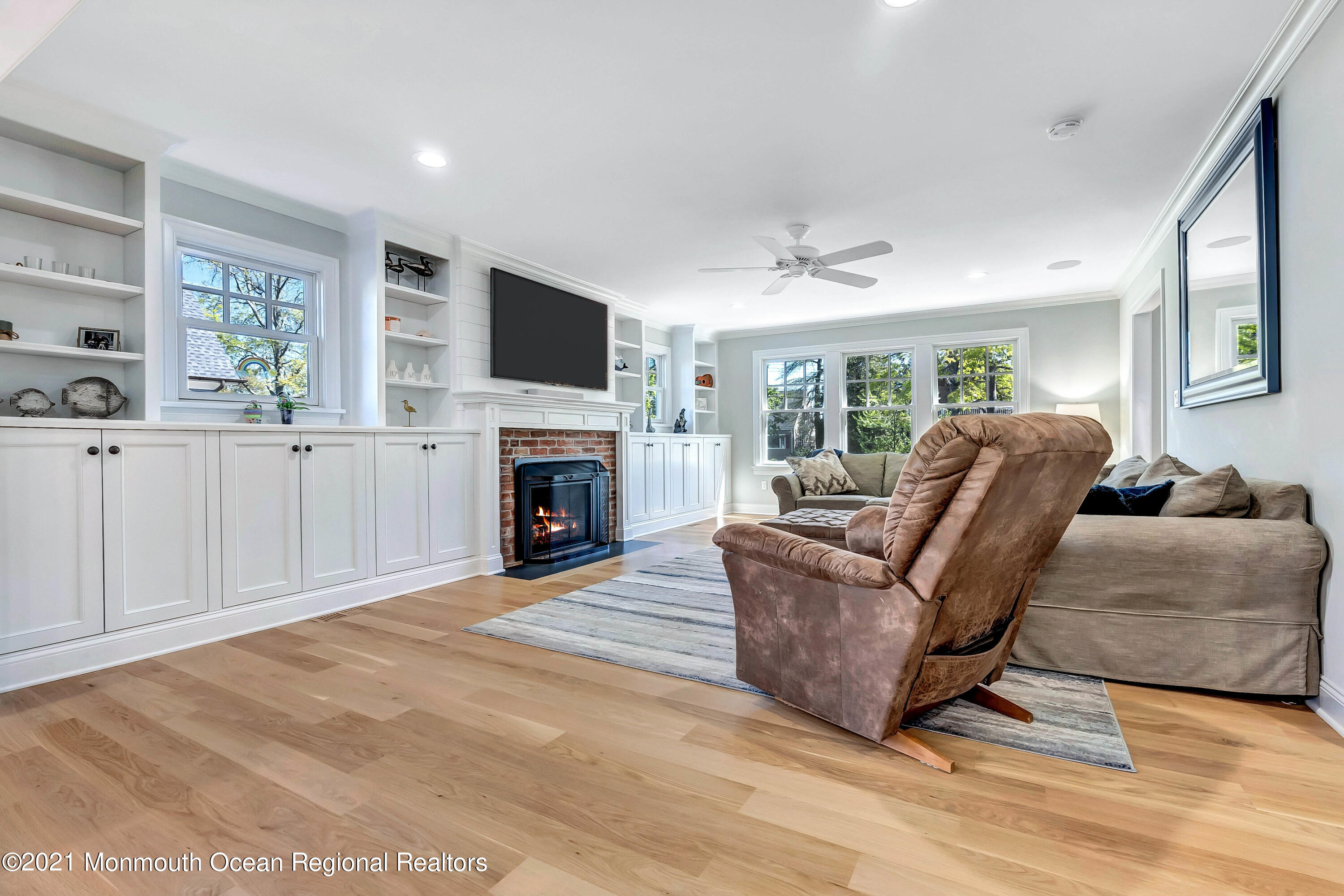 211 Monroe Avenue Spring Lake, NJ 07762 - Photo 9 of 46 a living room with furniture a flat screen tv and a fireplace