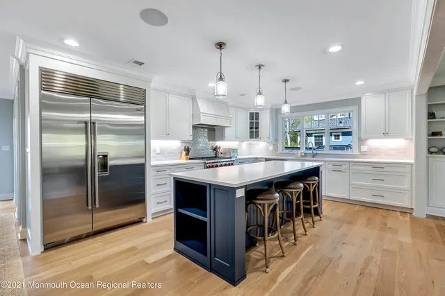 a kitchen with granite countertop a sink appliances and cabinets