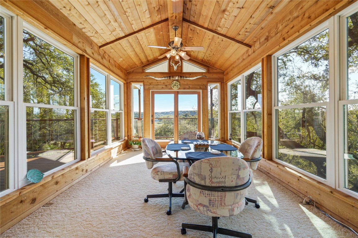 a dining room with furniture water view and a floor to ceiling window