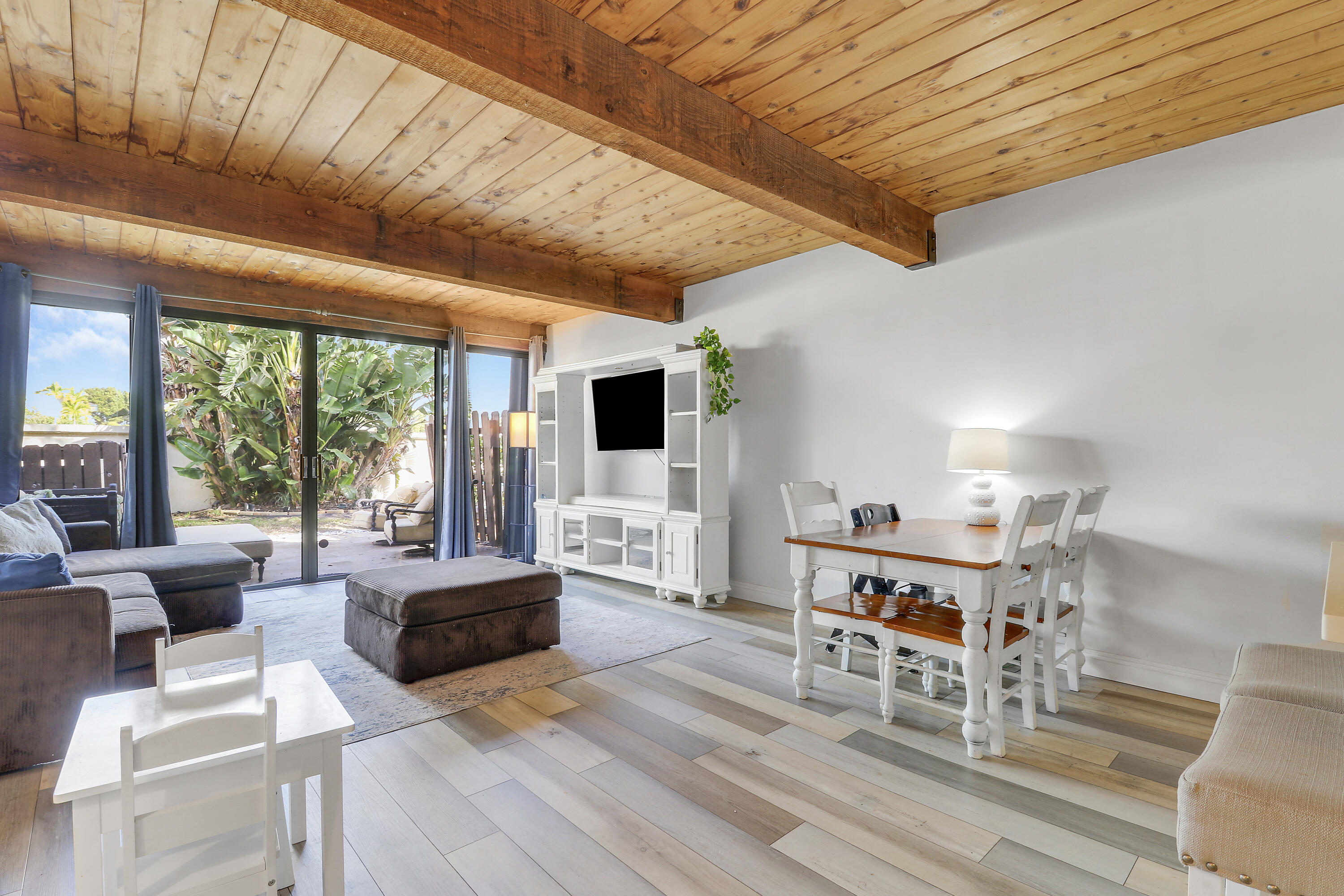 4801 Northwest 2nd Avenue, Unit 101 Boca Raton, FL 33431 - Photo 11 of 31 a living room with furniture and a flat screen tv